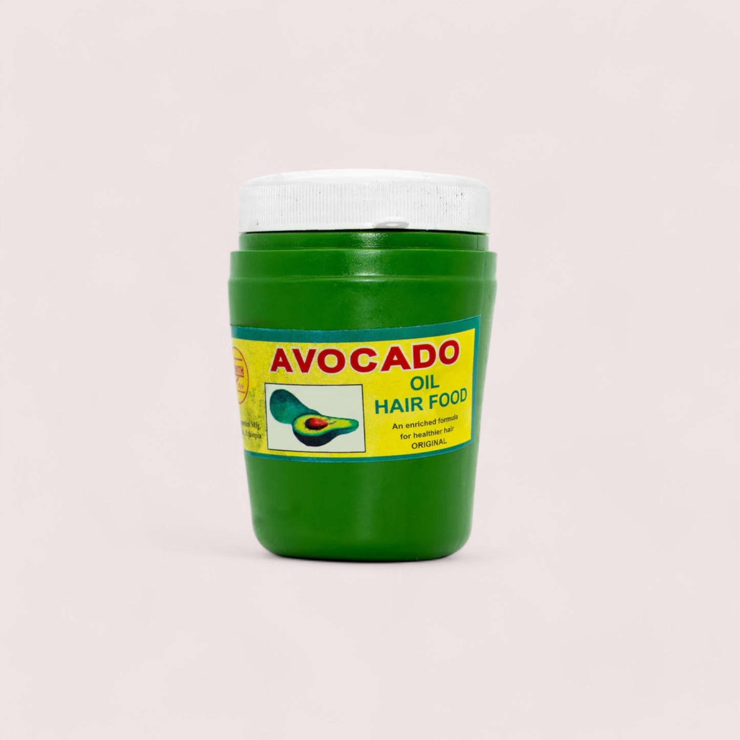 A green container of Avocado brand hair oil with a white lid. The label displays the product name and an image of an avocado.