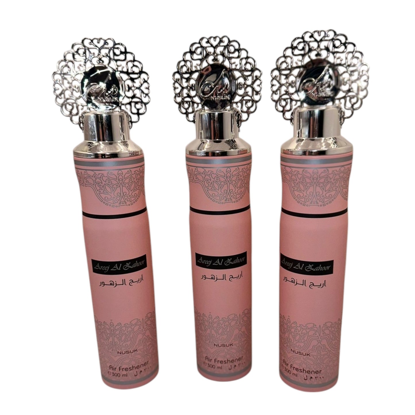 Three bottles of Al Ajeer air freshener with decorative caps, displayed against a white background.