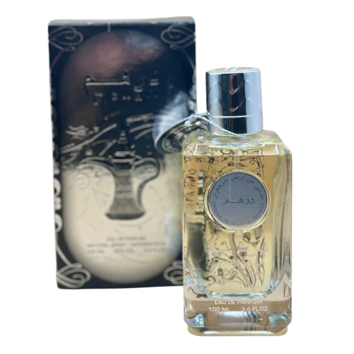 This image features the "Original Dirham Eau De Parfum" in a 100ml spray bottle, prominently displayed next to its ornately designed box. The perfume bottle is clear, revealing a golden-colored liquid, and is capped with a silver lid that carries the brand's logo.