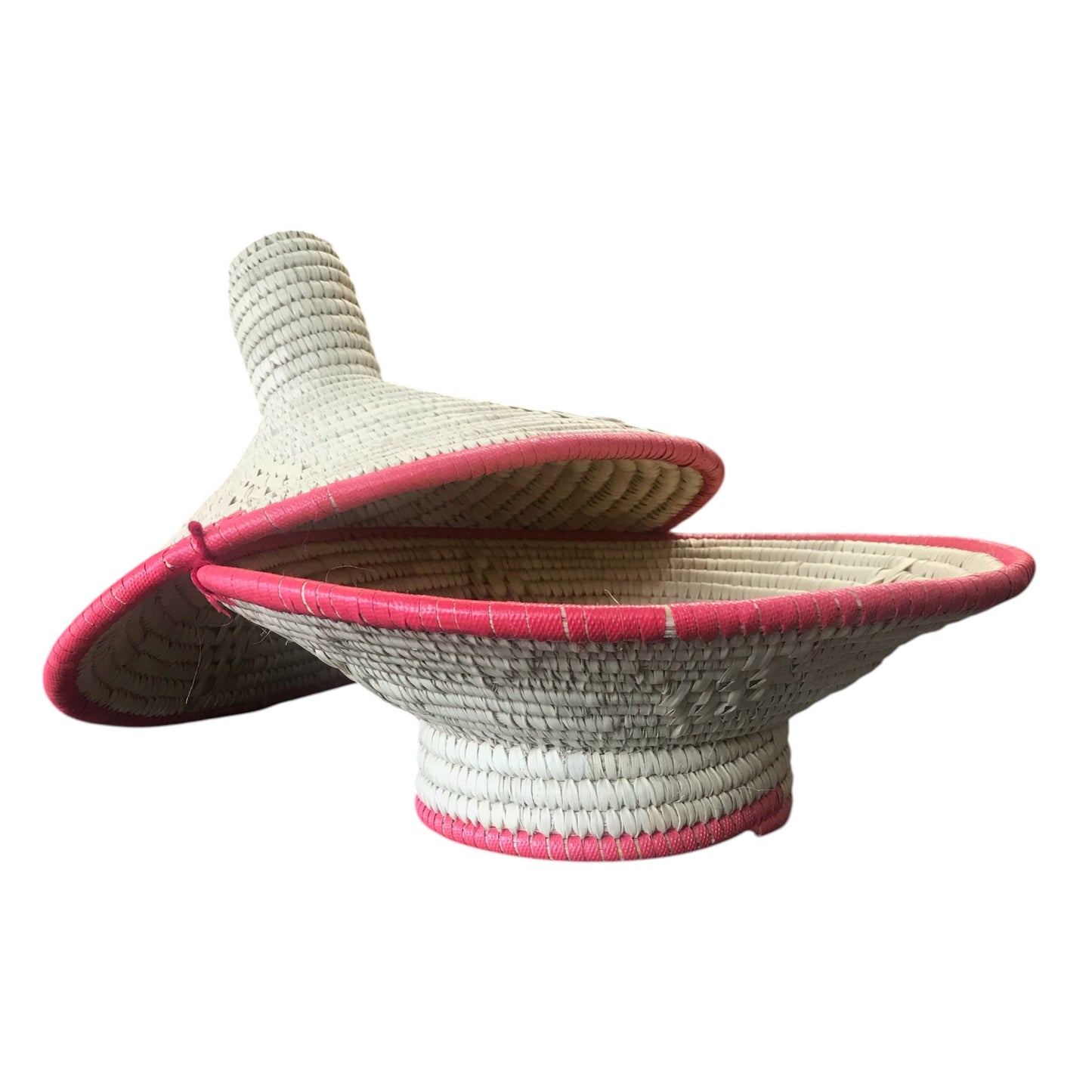 Woven sun hat with pink trim on a white background