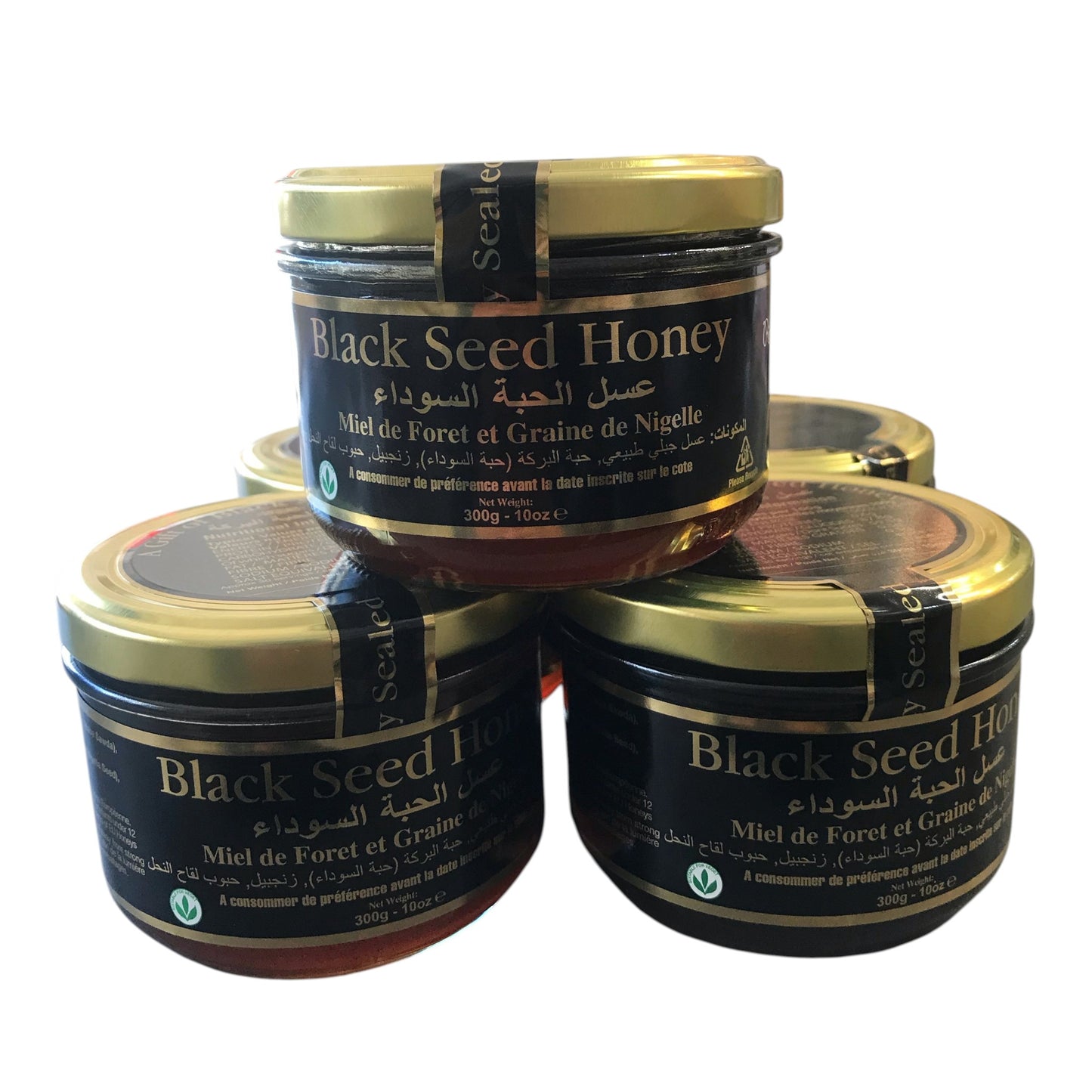 Four jars of Black Seed Honey stacked on a white background
