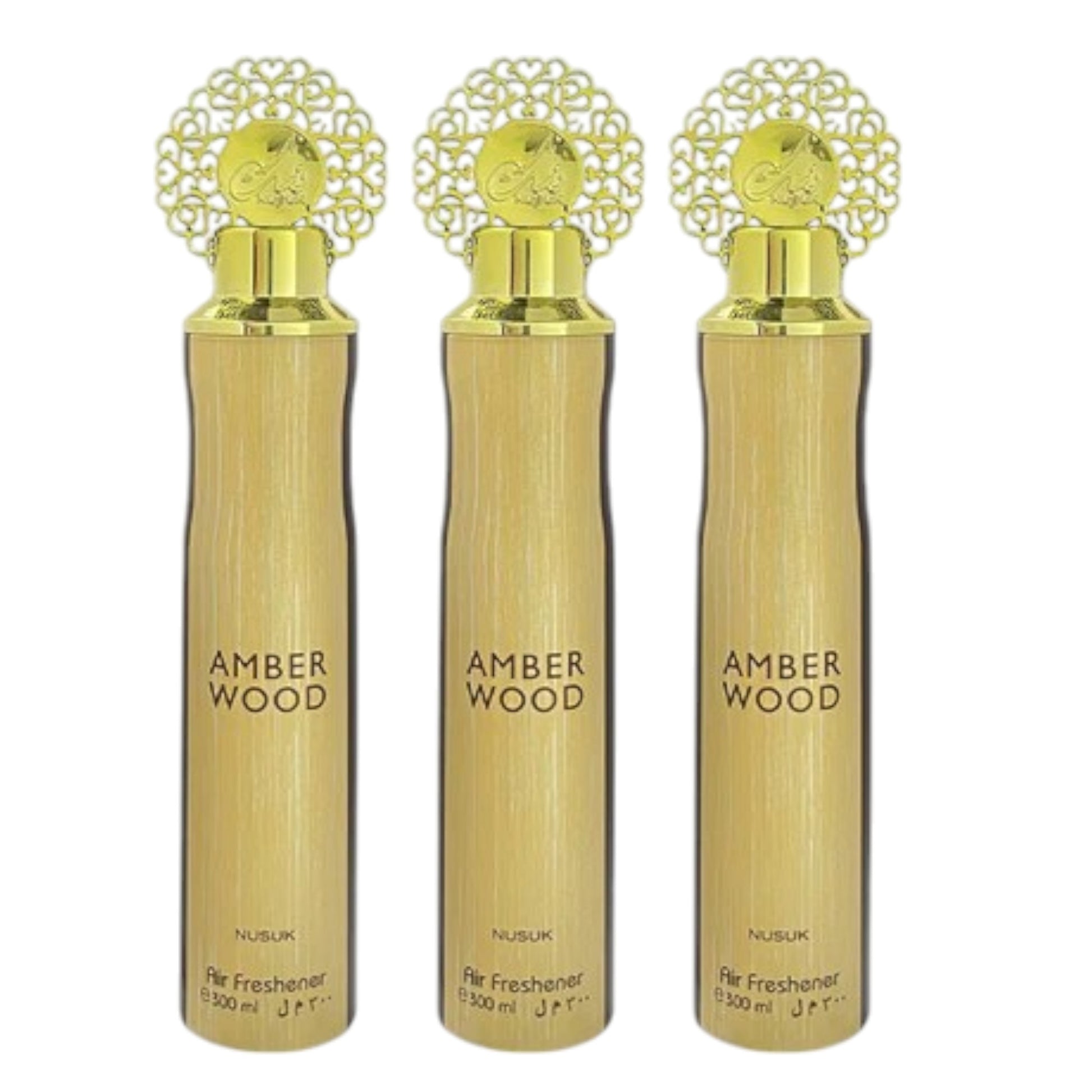 Three spray bottles labeled 'AMBER WOOD' from Nusk, with a decorative design on the caps.