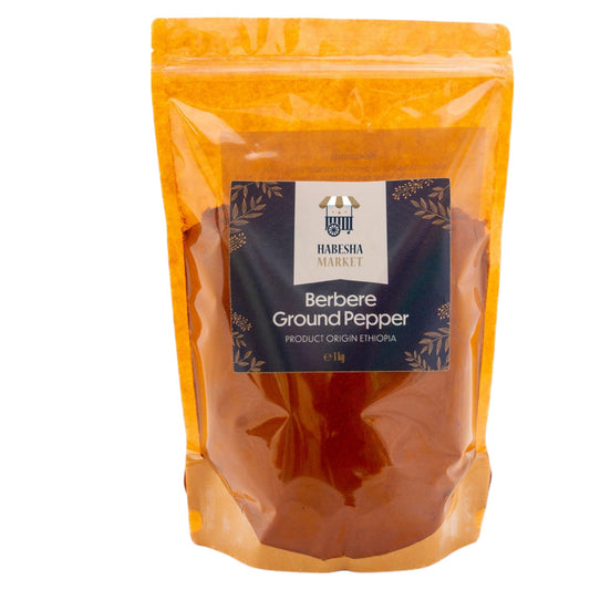 A package of Habesha Red Chili Powder Berbere in a yellow pouch with a label showing the product name and weight.