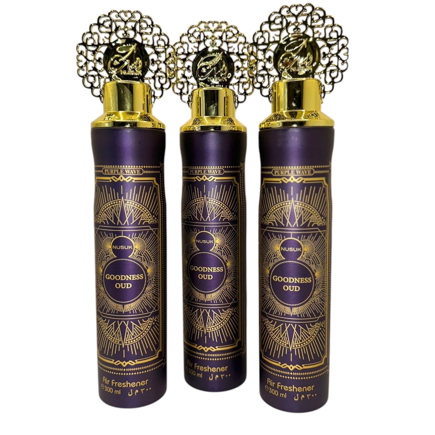 Three bottles of Goodness Oud air freshener with ornate gold caps on purple containers, labeled in Arabic.