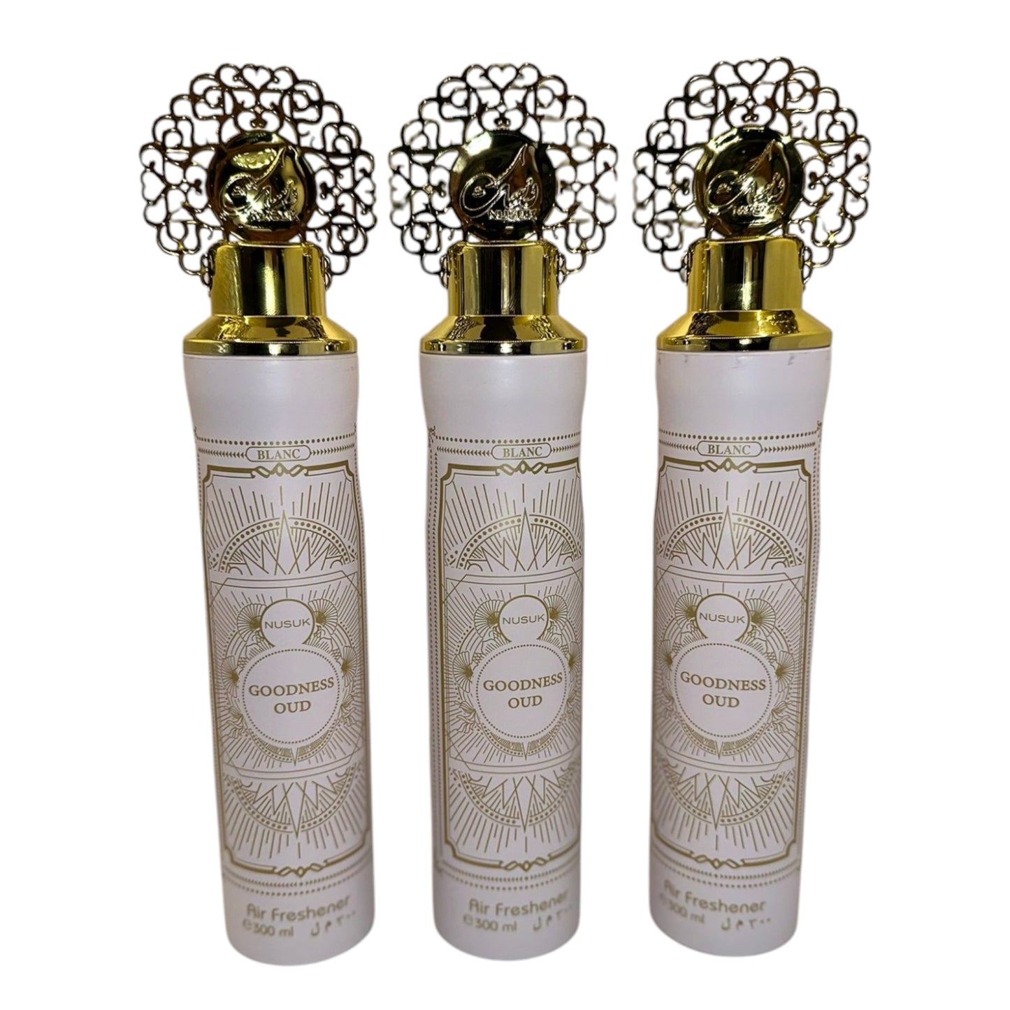 Three bottles of White Blanc air freshener with decorative gold caps and intricate patterns on the labels.