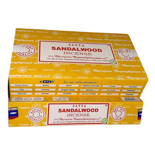 A pack of Satya Sandalwood incense sticks. The box is yellow with the brand name and product name displayed.