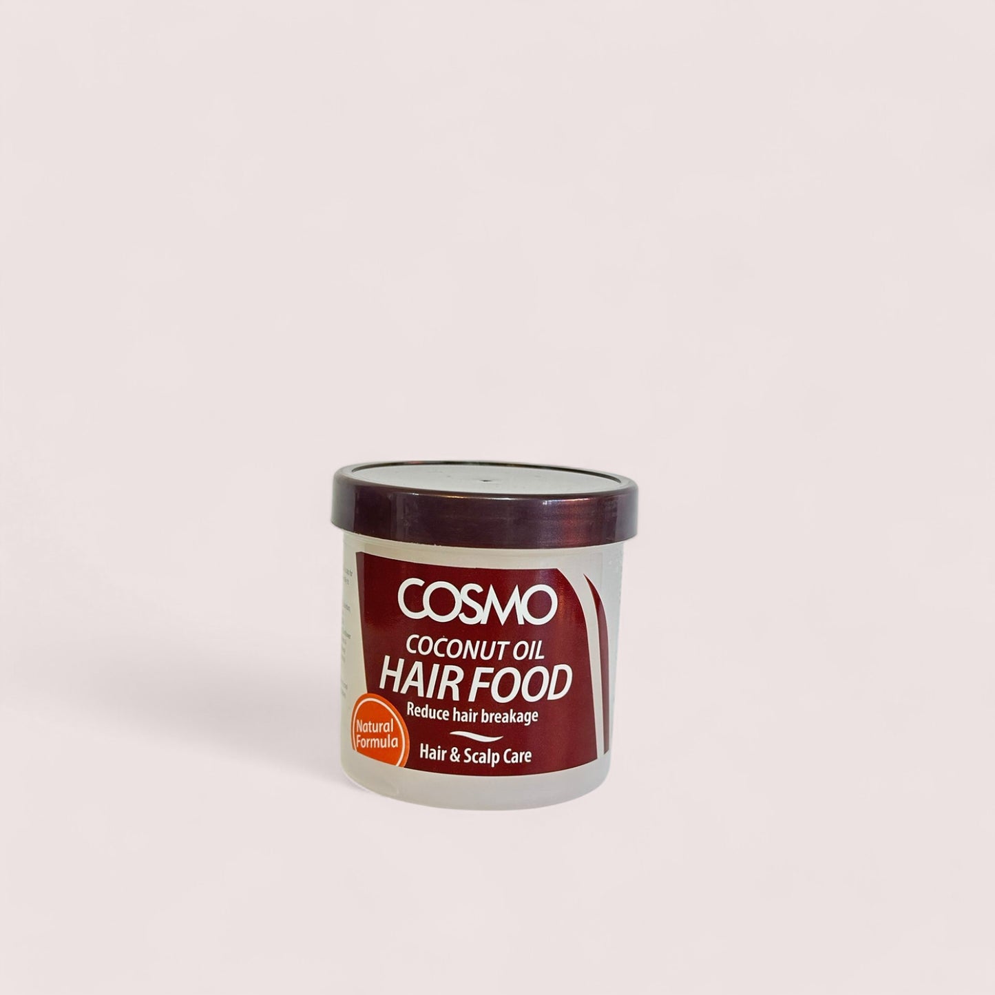 A container of Cosmo Coconut Hair Food Oil with the label showing the brand name, product name, and additional information.