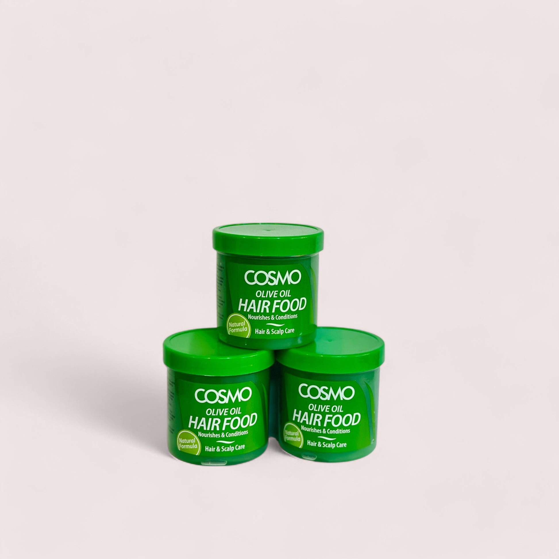 Three green containers of Cosmo Olive Oil Hair Food Natural Formula stacked together against a white background.