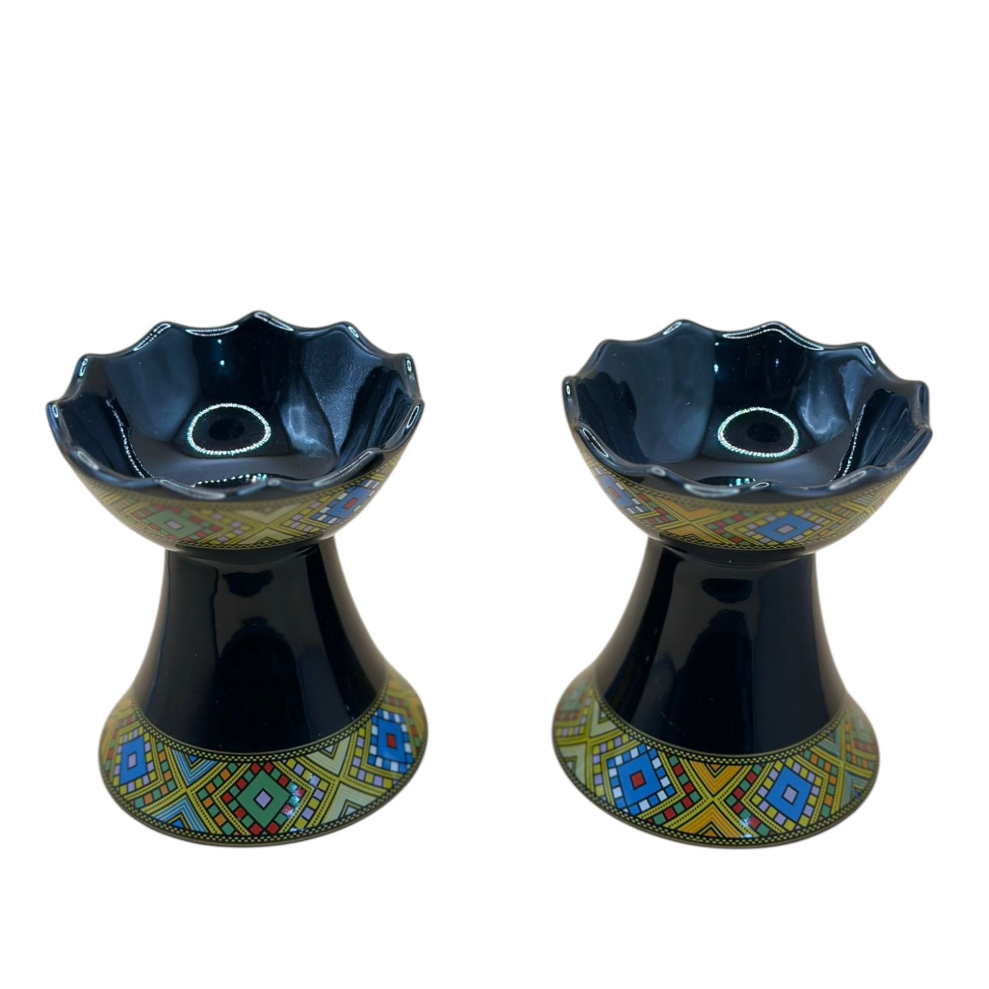 Two traditional ceramic incense burners with geometric patterns in black, blue, and yellow colors.