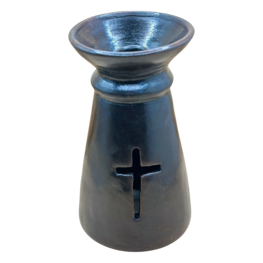 A black clay candle holder with a cross design at the base.