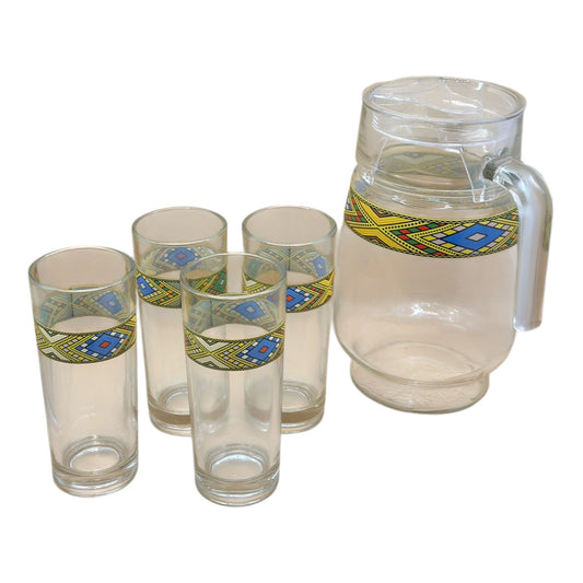 A set of Habesha Tilet Zuria glassware, including a designed glass jug and six tumbler glasses with geometric patterns around the upper part.