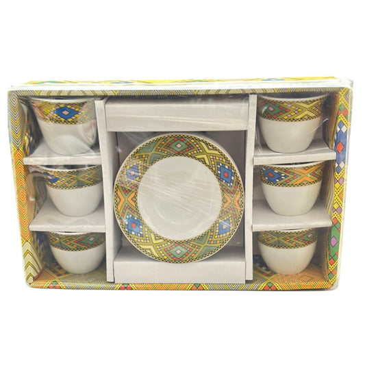 A set of Habesha styled coffee cups and plates with traditional geometric patterns, displayed in packaging.