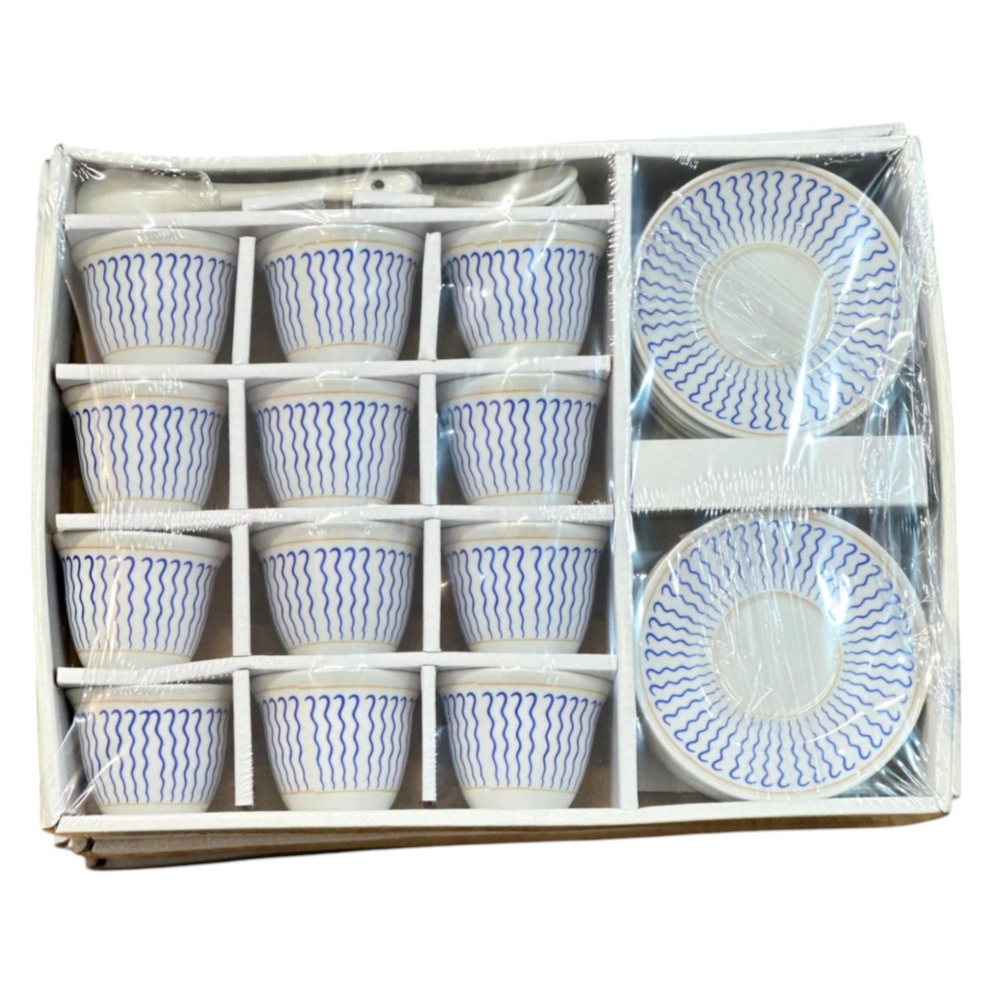 A set of Eritrean and Ethiopian ceramic coffee cups with saucers and spoons, packaged in a box, featuring a blue and white pattern.