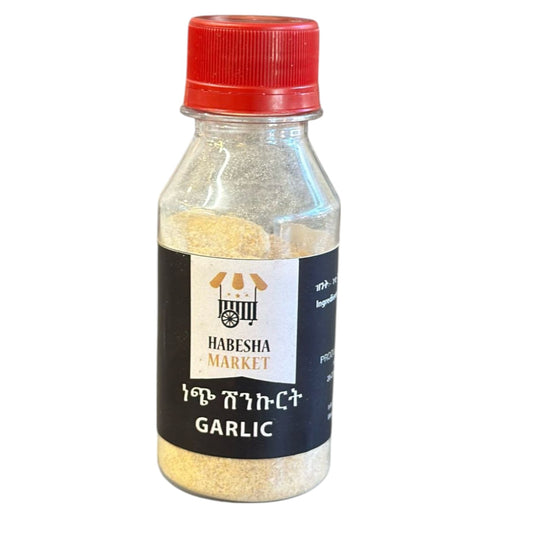 A bottle of garlic powder with a red cap labeled 'HABESHA MARKET GARLIC'.