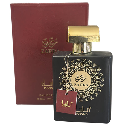 Perfume bottle with gold cap and decorative label next to a red box labeled 'Zahra' on a white background.