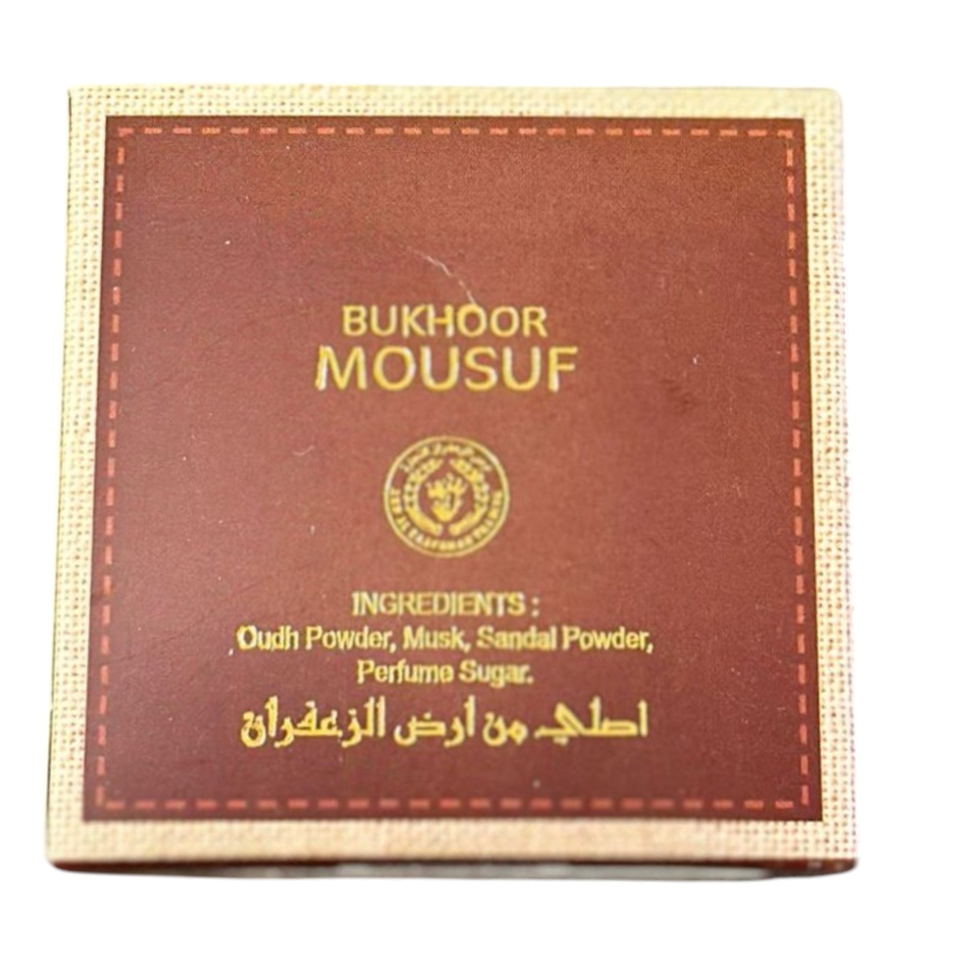 A box of Mousuf Bukhoor with ingredients listed on the packaging, including Oud Powder, Musk, Sandal Powder, and Perfume Sugar.