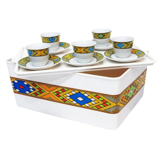A plastic Rekobot box with a geometric pattern used as a holder and server for Habesha traditional coffee, including cups and a tray.