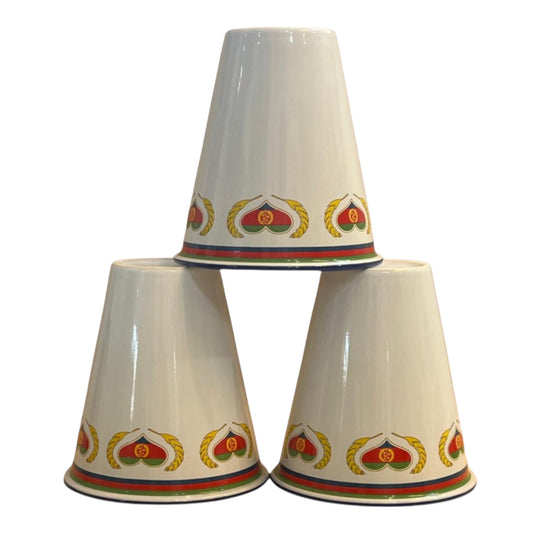 A set of three white porcelain cups with Eritrean flag inspired geometric patterns in red, yellow, and green colors.