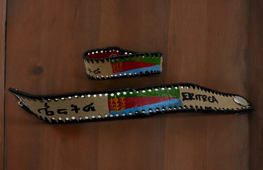 A handmade leather bracelet featuring the colors and flag symbols of Eritrea.