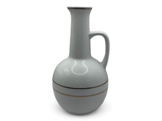 A white ceramic Habesha Jebena coffee pot with zuria design stripes, used for making traditional coffee ceremony.