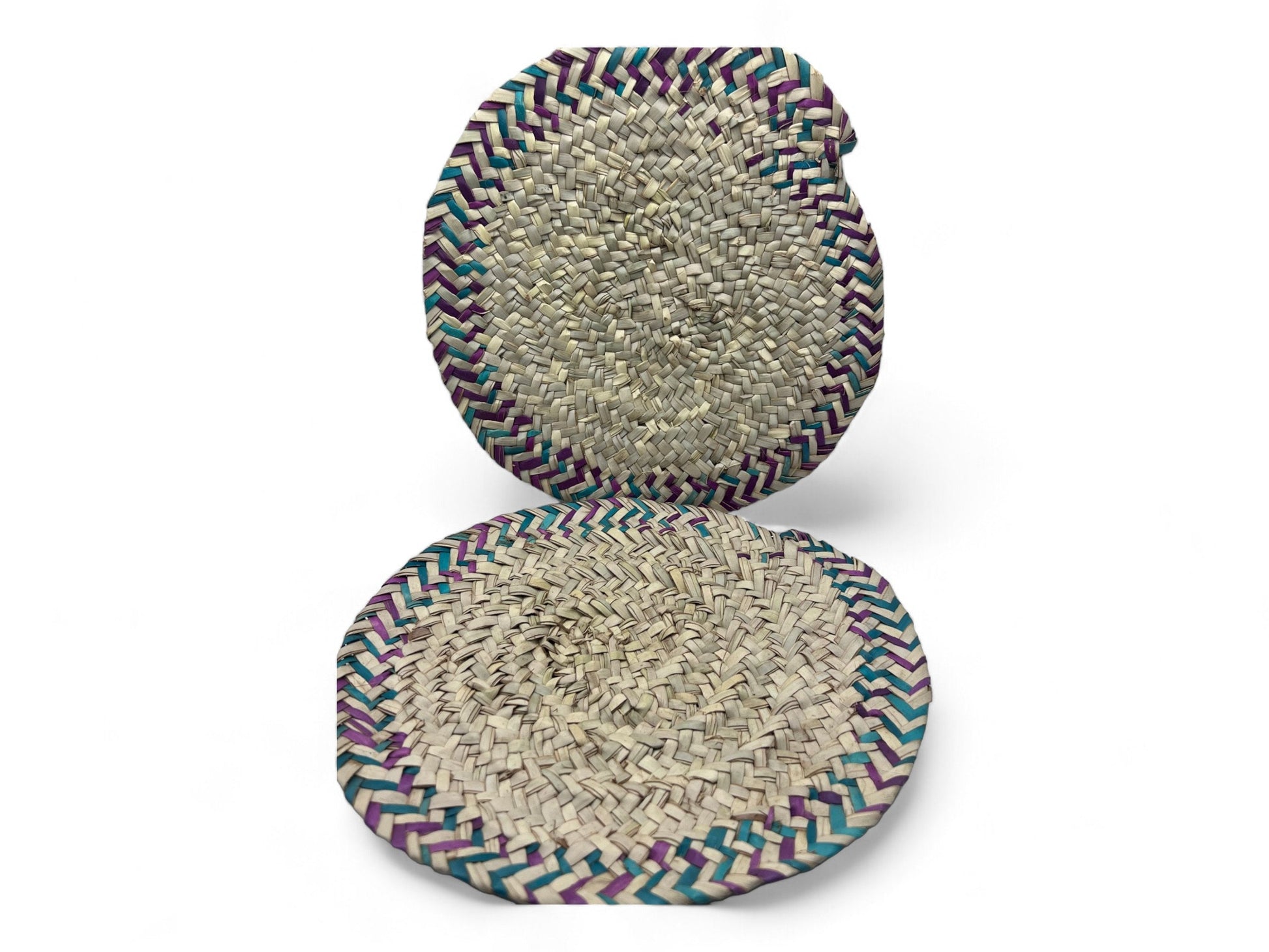 Two traditional woven palm leaf fire fans with multicolored edges.