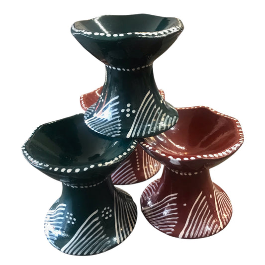 Three ceramic tiered stands in black, red, and white with decorative patterns on a white background.