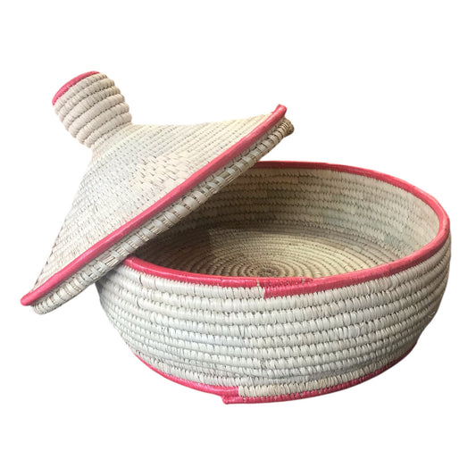Woven basket with pink trim and matching lid on a white background