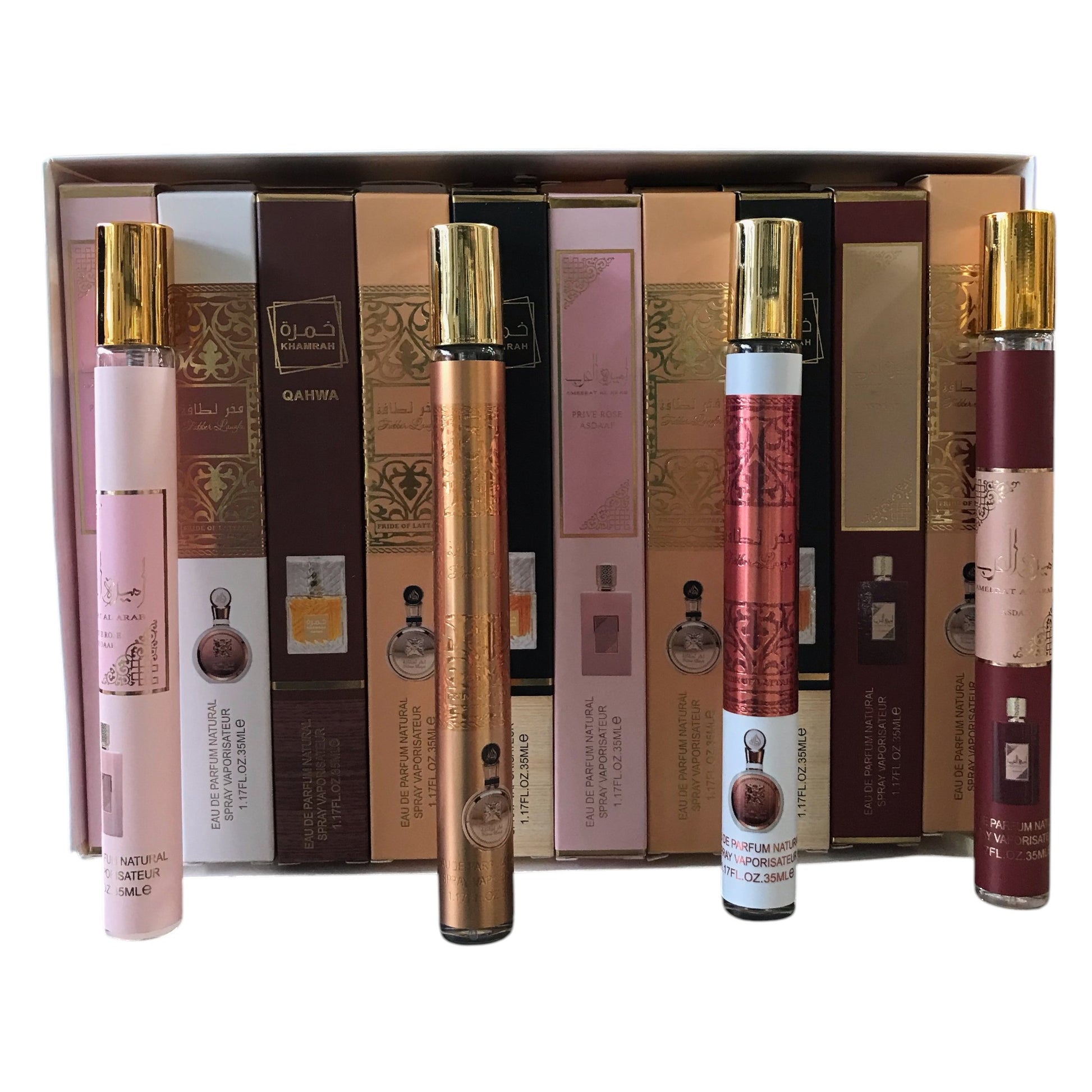 Set of perfume bottles with gold caps in front of their packaging