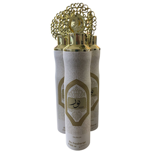 Three white and gold bottles with decorative caps on a white background