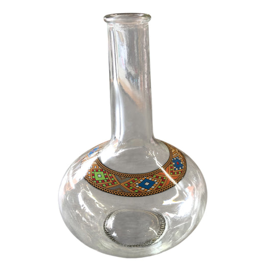 Clear glass vase with decorative base on a white background