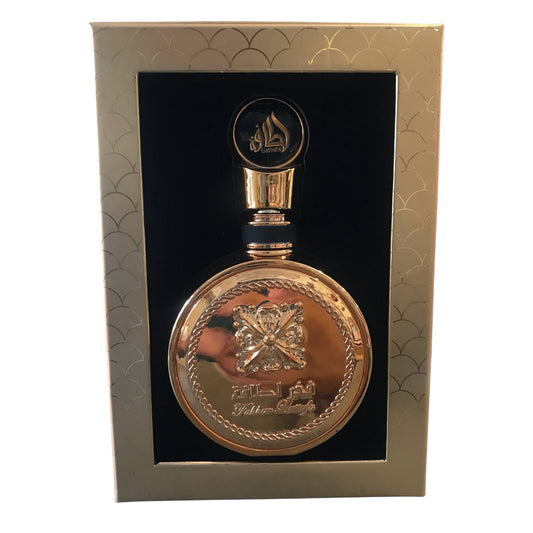 Gold decorative bottle with intricate design in a gold box