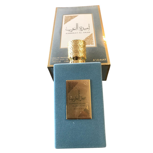 Blue perfume bottle with gold cap and label on a white background